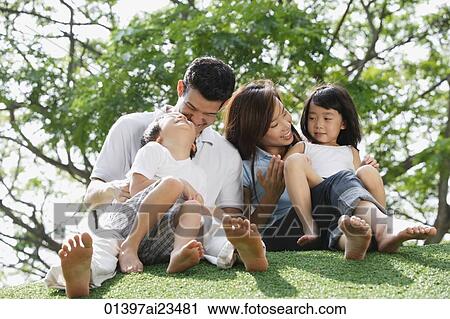 Young family sitting on ground at the park View Large Photo Image Stock Image - Young family sitting on ground at the park. Fotosearch