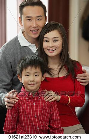 Young family smiling at camera View Large Photo Image Stock Image - Young family smiling at camera. Fotosearch