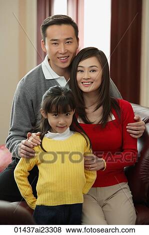 Stock Photo - Young family smiling at camera. Fotosearch