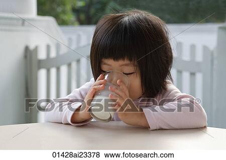 Stock Photo - Young girl drinking glass of milk. Fotosearch