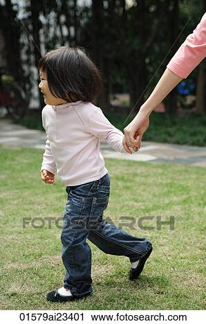 Young girl holding mother's hand while walking View Large Photo Image Stock Image - Young girl holding mother's hand while walking. Fotosearch