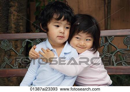 Young girl hugging young boy View Large Photo Image Stock Image - Young girl hugging young boy. Fotosearch