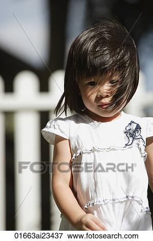 Stock Photo - Young girl in backyard. Fotosearch