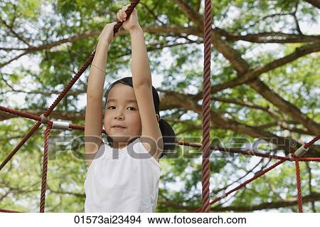 Young girl playing at the park, looking at camera View Large Photo Image Picture - Young girl playing at the park, looking at camera. Fotosearch