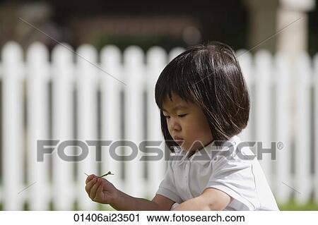 Young girl playing in the garden View Large Photo Image Stock Image - Young girl playing in the garden. Fotosearch