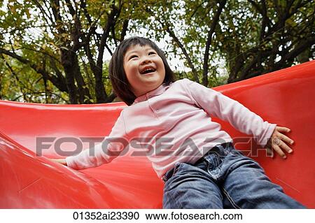 Young girl playing on slide View Large Photo Image Stock Image - Young girl playing on slide. Fotosearch