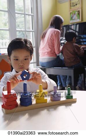 Young girl playing with building blocks View Large Photo Image Stock Image - Young girl playing with building blocks. Fotosearch