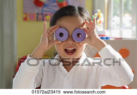 Young girl playing with stacking blocks, looking at camera View Large Photo Image Stock Photography - Young girl playing with stacking blocks, looking at camera. Fotosearch