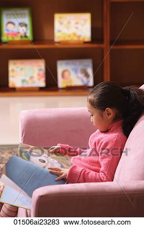 Young girl reading a book View Large Photo Image Stock Image - Young girl reading a book. Fotosearch