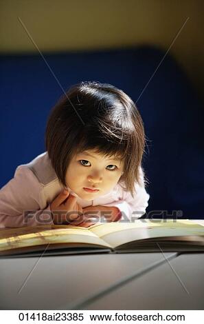 Young girl with book, looking at camera View Large Photo Image Stock Photography - Young girl with book, looking at camera. Fotosearch