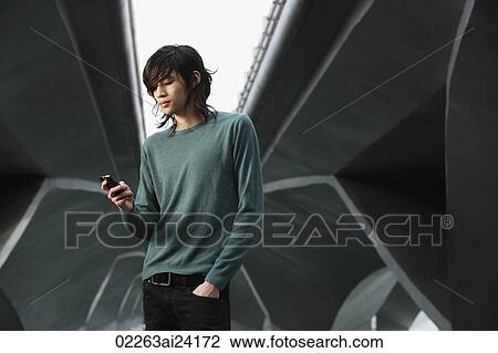 young man checking text messages View Large Photo Image Stock Image - young man checking text messages. Fotosearch