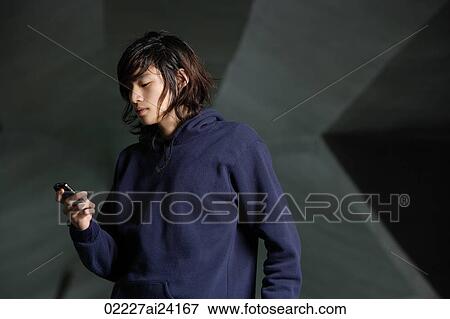Stock Photo - young man checking text messages. Fotosearch
