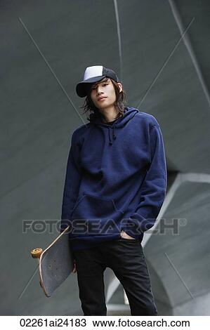 young man holding skateboard View Large Photo Image Stock Image - young man holding skateboard. Fotosearch
