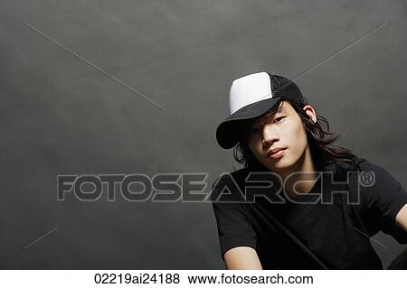 Stock Photo - young man in cap. Fotosearch