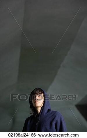 Stock Photograph - young man in hooded sweatshirt. Fotosearch