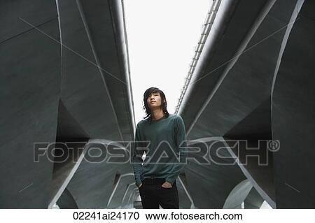 Stock Image - young man under freeway overpass. Fotosearch
