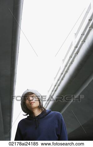 Stock Photography - young man wearing hat, looking up. Fotosearch