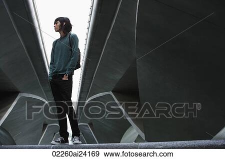 young man with backpack, standing under bridge View Large Photo Image Stock Photo - young man with backpack, standing under bridge. Fotosearch