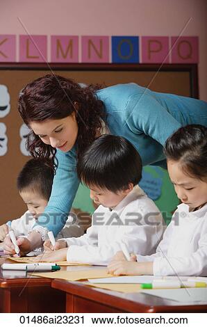 Young school children with their teacher View Large Photo Image Stock Image - Young school children with their teacher. Fotosearch