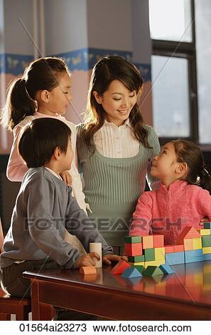 Young school children with their teacher View Large Photo Image Stock Image - Young school children with their teacher. Fotosearch