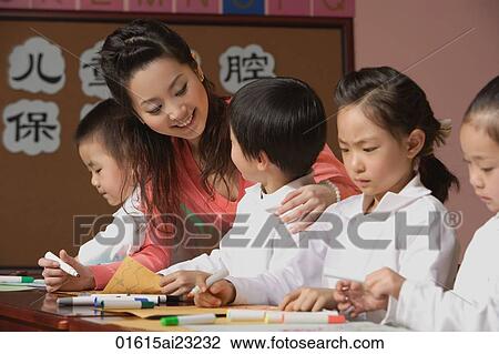 Young school children with their teacher View Large Photo Image Stock Image - Young school children with their teacher. Fotosearch