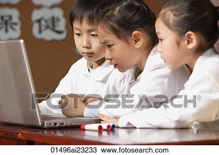Young students using laptop in class View Large Photo Image Stock Image - Young students using laptop in class. Fotosearch