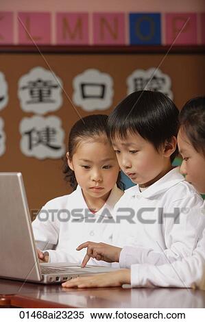 Young students using laptop in class, schoolboy typing on keypad View Large Photo Image Stock Photography - Young students using laptop in class, schoolboy typing on keypad. Fotosearch