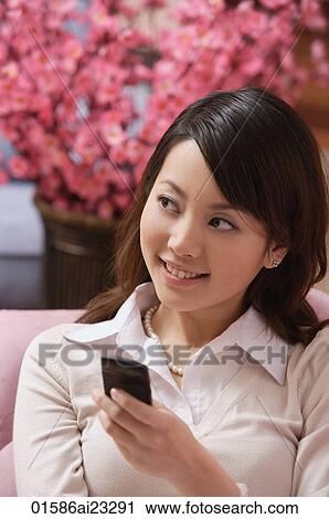Young woman using mobile phone View Large Photo Image Stock Image - Young woman using mobile phone. Fotosearch