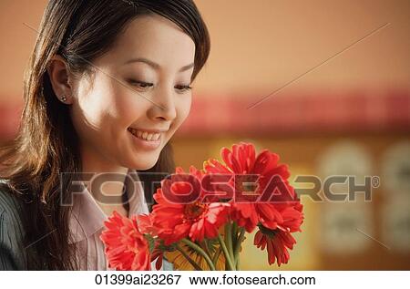 Young woman with flowers View Large Photo Image Stock Photo - Young woman with flowers. Fotosearch
