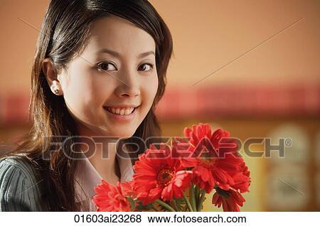 Young woman with flowers View Large Photo Image Stock Photo - Young woman with flowers. Fotosearch