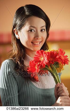 Young woman with flowers View Large Photo Image Stock Photograph - Young woman with flowers. Fotosearch