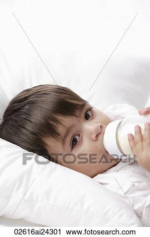 Stock Image - baby boy drinking from bottle. Fotosearch