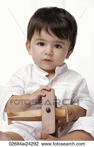 baby boy holding toy airplane View Large Photo Image Stock Image - baby boy holding toy airplane. Fotosearch