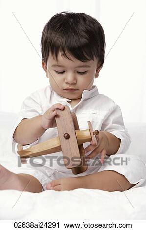 baby boy playing with toy airplane View Large Photo Image Stock Image - baby boy playing with toy airplane. Fotosearch