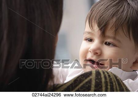 Stock Photograph - baby boy smiling at mother. Fotosearch