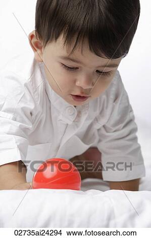 Picture - baby boy with red ball. Fotosearch