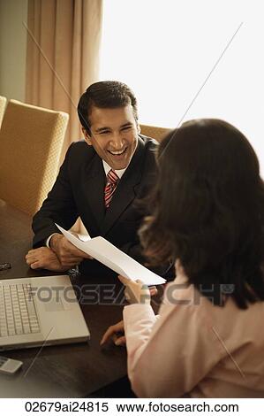 Stock Photography - business associates having meeting, laptop computer. Fotosearch