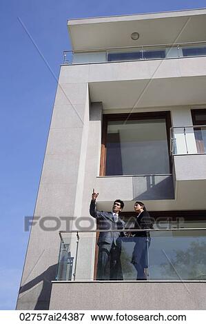 Stock Photo - business associates talking at balcony. Fotosearch