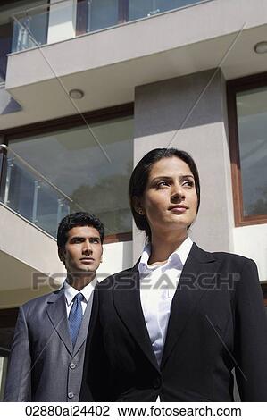 businessman and woman standing in front of building View Large Photo Image Stock Image - businessman and woman standing in front of building. Fotosearch