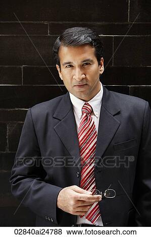 businessman in suit, glasses in hand View Large Photo Image Stock Photo - businessman in suit, glasses in hand. Fotosearch
