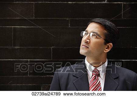 Stock Photo - businessman in suit, glasses. Fotosearch