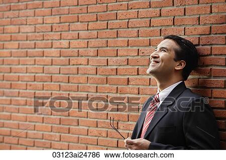 businessman leaning against wall View Large Photo Image Stock Photograph - businessman leaning against wall. Fotosearch