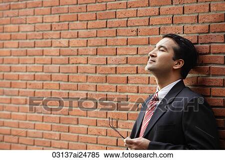businessman leaning against wall View Large Photo Image Stock Photography - businessman leaning against wall. Fotosearch