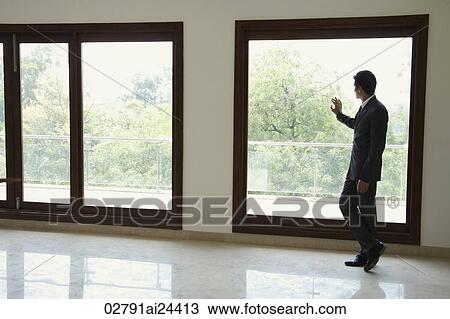 businessman next to window, hand on window View Large Photo Image Stock Image - businessman next to window, hand on window. Fotosearch