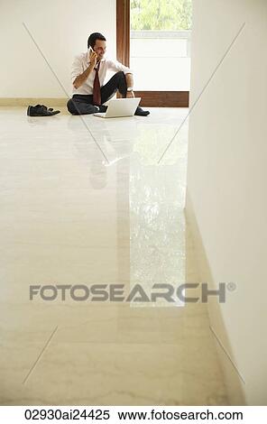 businessman on floor, with cell phone and lap top computer View Large Photo Image Stock Photography - businessman on floor, with cell phone and lap top computer. Fotosearch