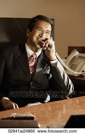 Stock Image - businessman on phone, in office. Fotosearch