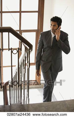 businessman on phone, walking up stairs View Large Photo Image Stock Photograph - businessman on phone, walking up stairs. Fotosearch