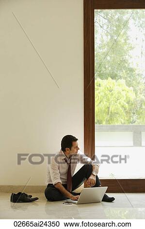 businessman sitting on ground with computer View Large Photo Image Stock Image - businessman sitting on ground with computer. Fotosearch