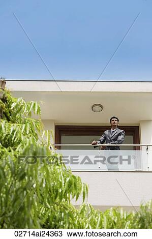Stock Image - businessman standing at balcony. Fotosearch