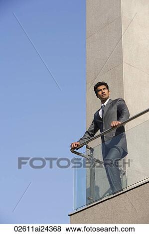 businessman standing at balcony View Large Photo Image Stock Photo - businessman standing at balcony. Fotosearch